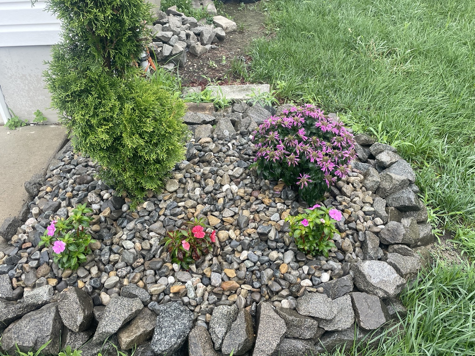 Decorative stone and flower landscaping by Touch Of Country Landscaping LLC